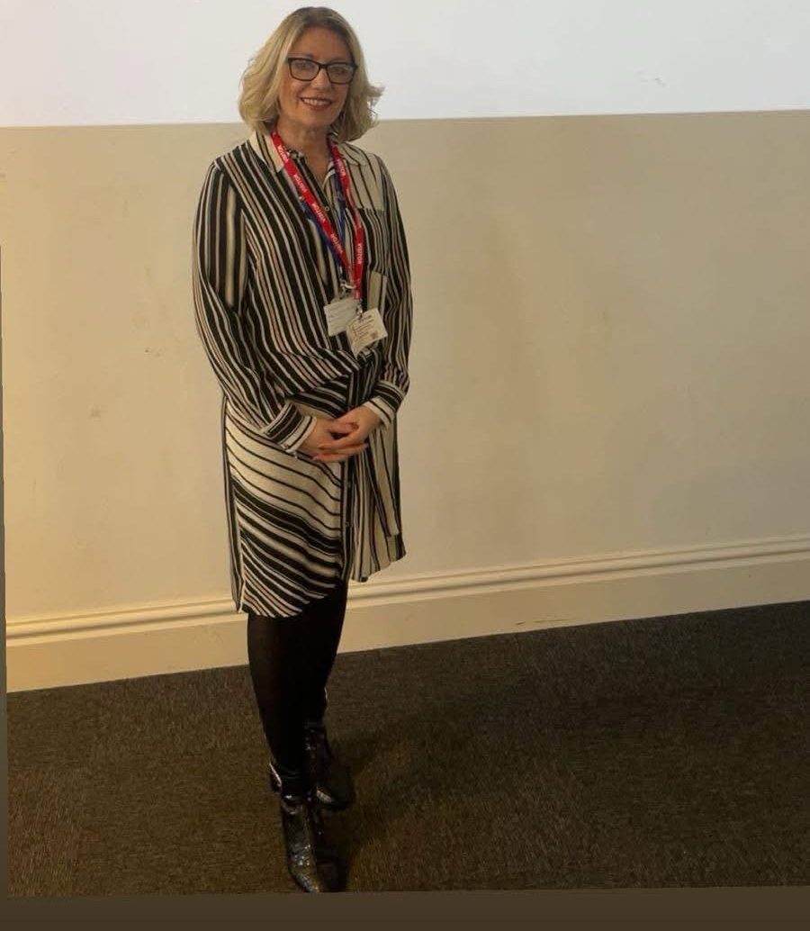 Clare Blackmore standing in front of the presentation screen at a parent wellbeing workshop